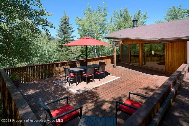 a view of a roof deck with furniture