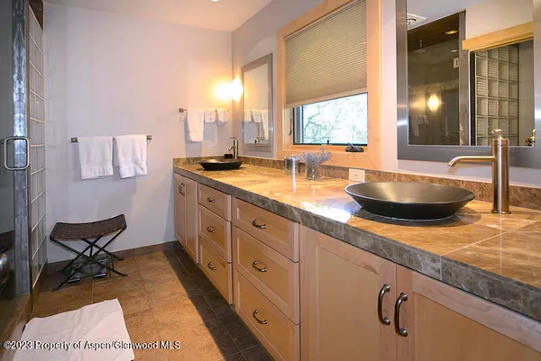 a spacious bathroom with double vanity and a granite counter tops