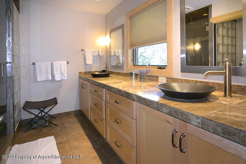 309 Mountain Laurel Drive Aspen, CO 81611 - Photo 8 of 14 a spacious bathroom with double vanity and a granite counter tops