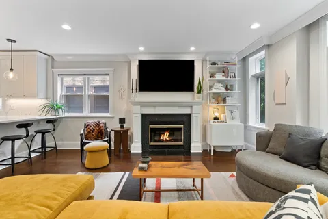a living room with furniture fireplace and flat screen tv