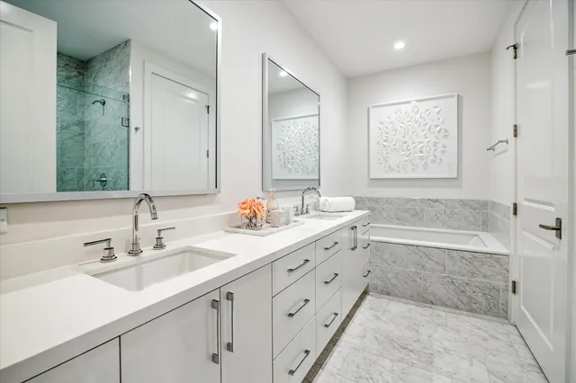 a living room with furniture a flat screen tv and kitchen view