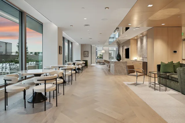a kitchen with cabinets appliances and a dining table
