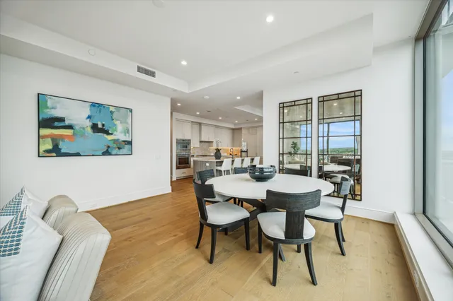 a view of a livingroom with furniture and floor to ceiling window
