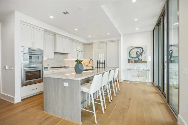 a living room with furniture a fireplace and a chandelier