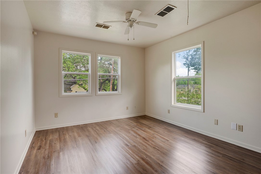 400 Robertson Street Bryan, TX 77803 - Photo 7 of 9 a view of an empty room with wooden floor and a window