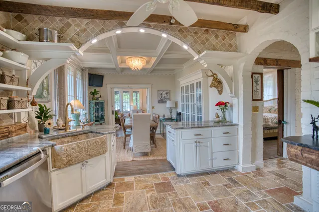a kitchen with stainless steel appliances granite countertop a stove and cabinets