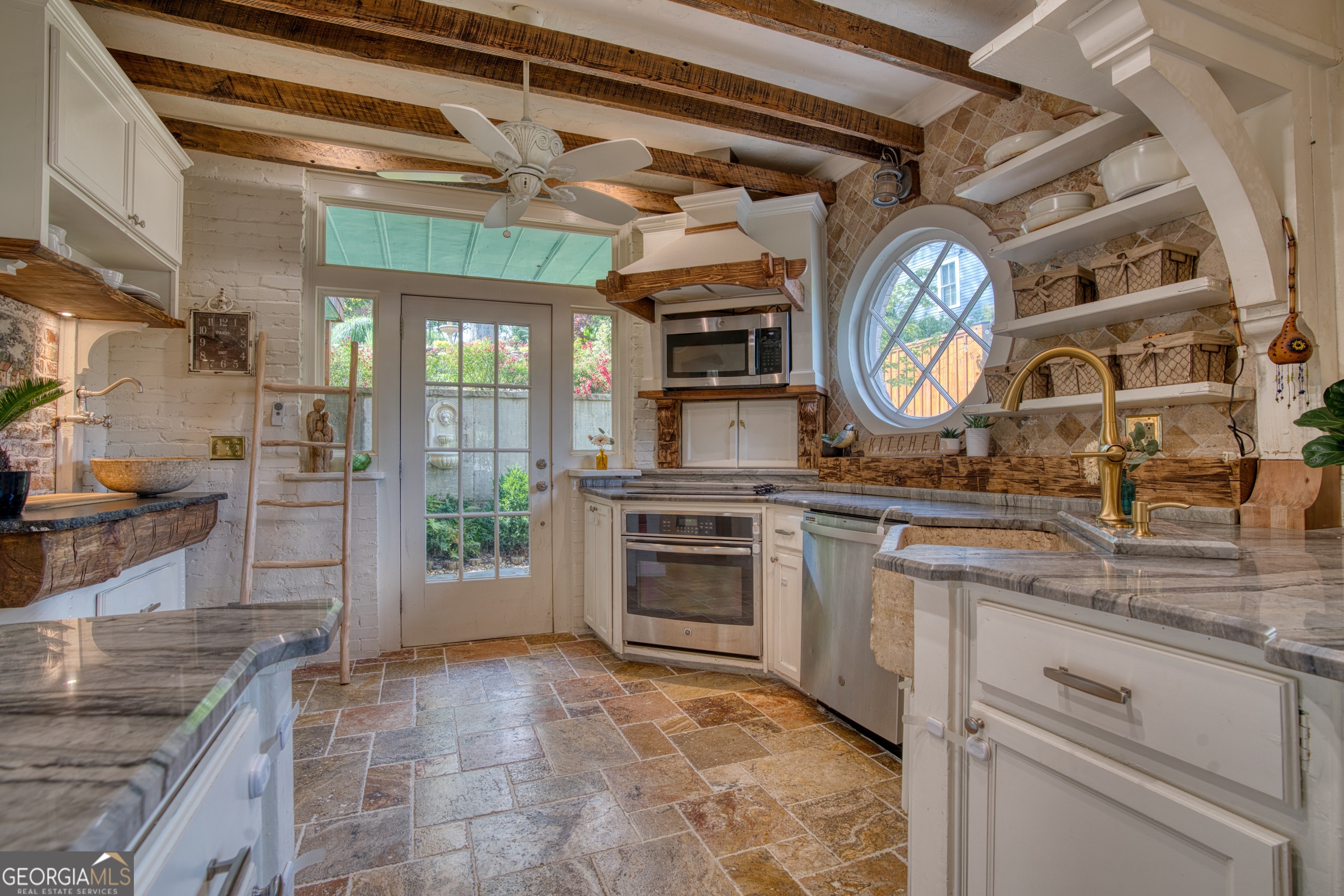 407 East 3rd Street Rome, GA 30161 - Photo 14 of 78 a kitchen with stainless steel appliances granite countertop a stove and cabinets