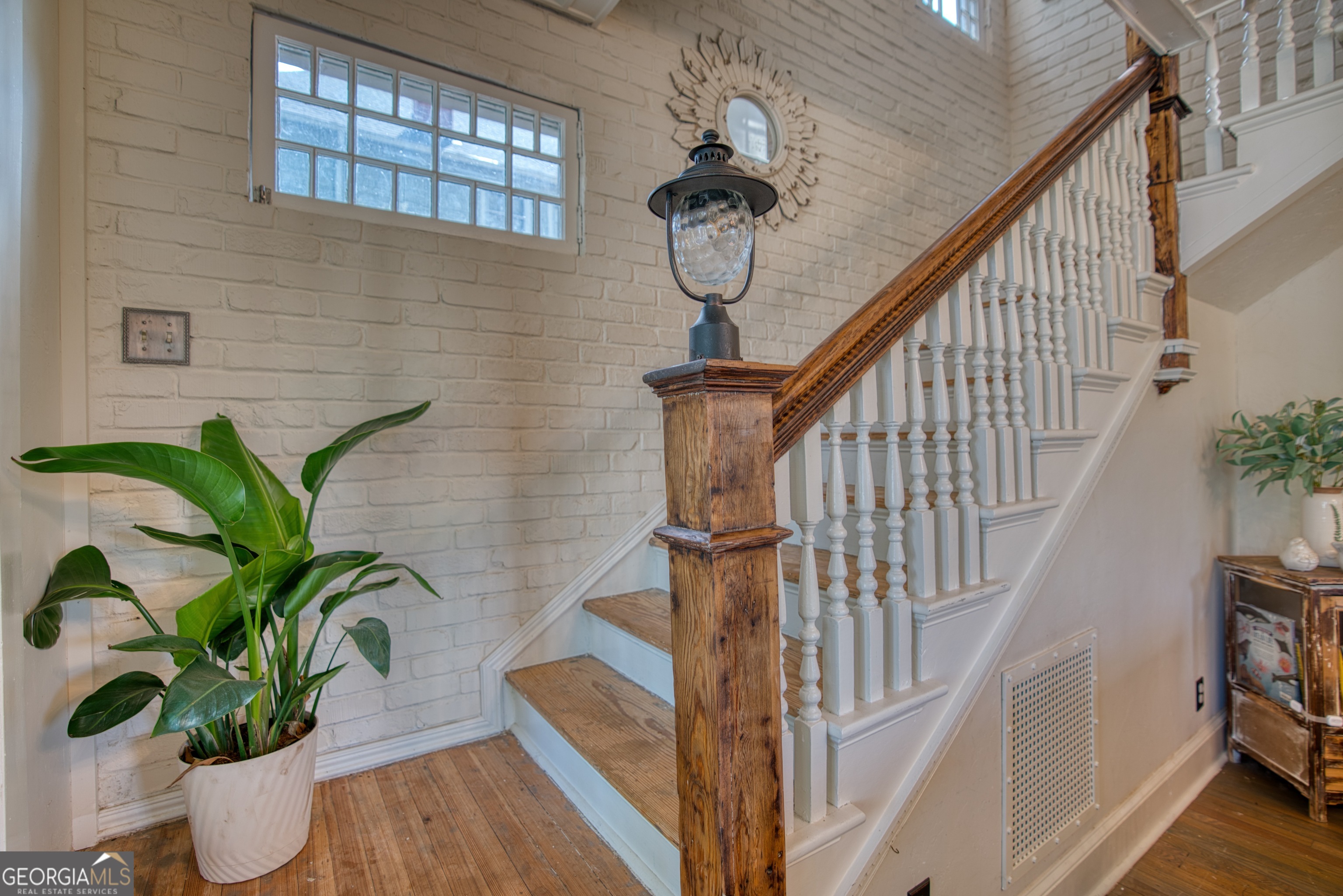 407 East 3rd Street Rome, GA 30161 - Photo 22 of 78 a view of staircase with wooden floor and a potted plant
