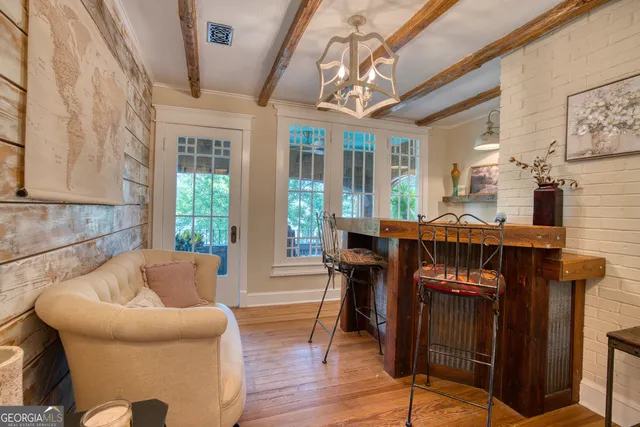 a living room with furniture a wooden floor and a large window