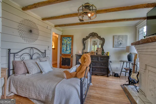 a view of entryway bedroom and hall with wooden floor