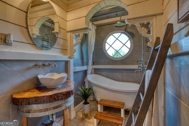 a bathroom with a toilet sink and mirror