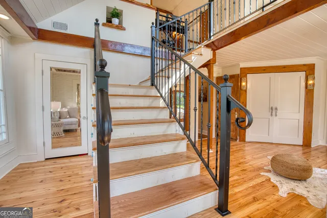 a view of a patio with table and chairs with wooden fence