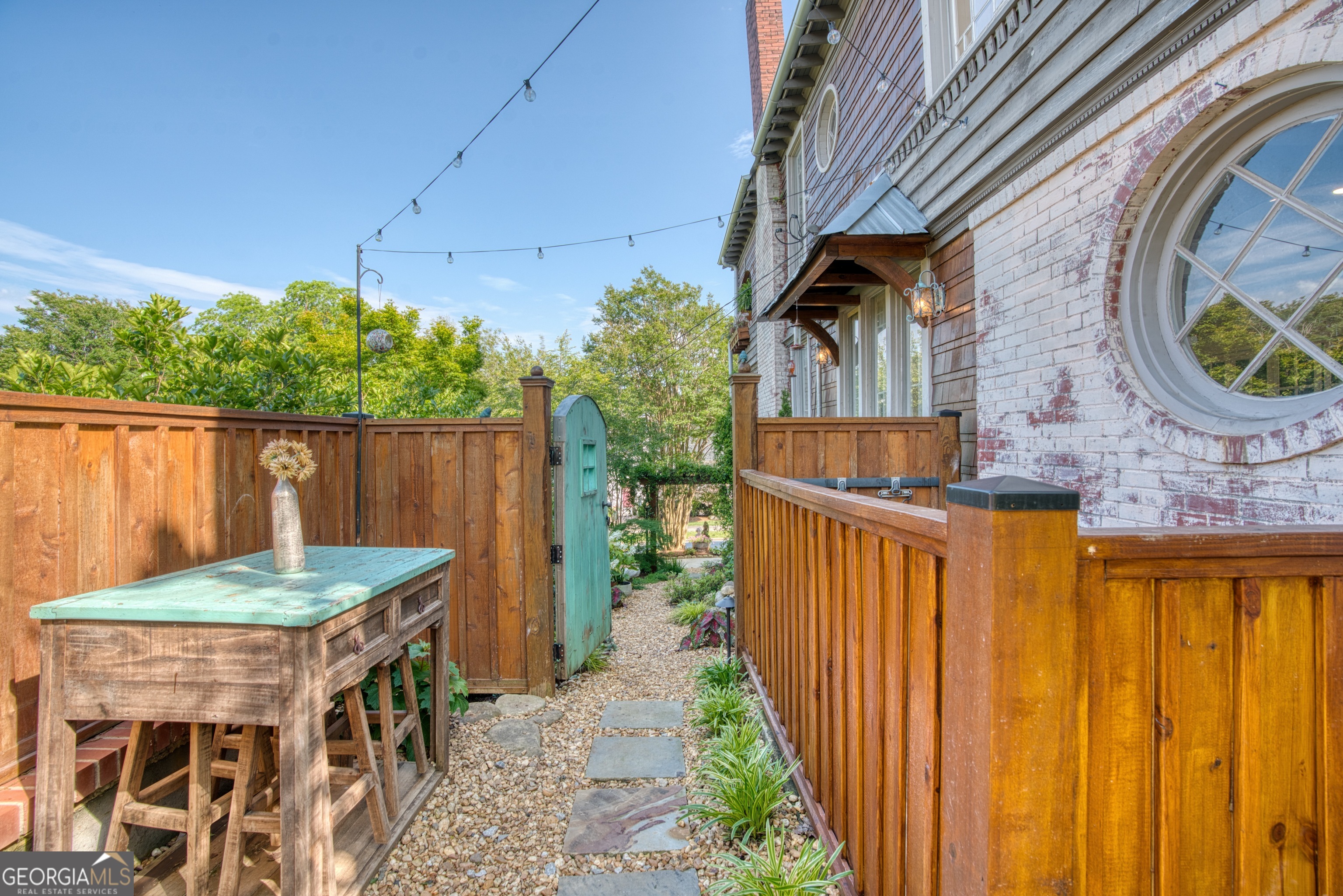 407 East 3rd Street Rome, GA 30161 - Photo 52 of 78 a view of a patio with table and chairs with wooden fence