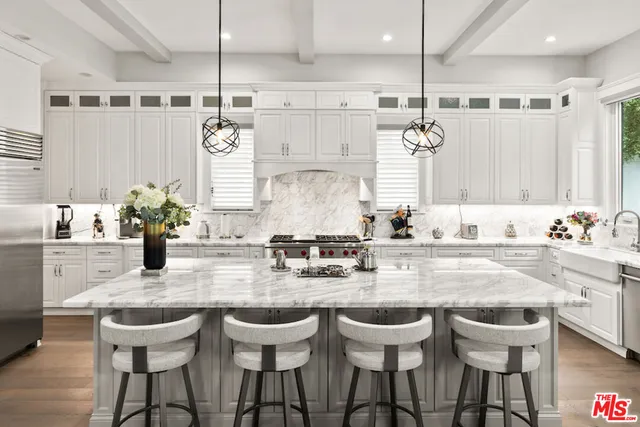 a kitchen with stainless steel appliances granite countertop a sink a stove oven a counter space and cabinets