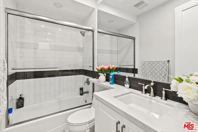 a spacious bedroom with a large bed and a large window