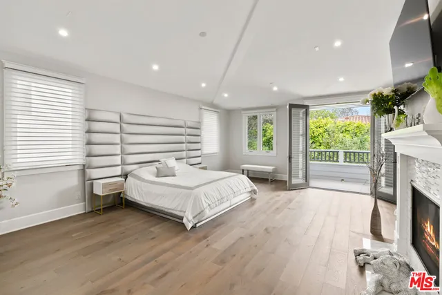 a spacious bathroom with a double vanity sink large mirror a bathtub and next to a window
