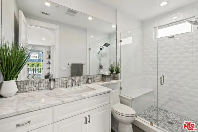 a spacious bedroom with a bed and a large window