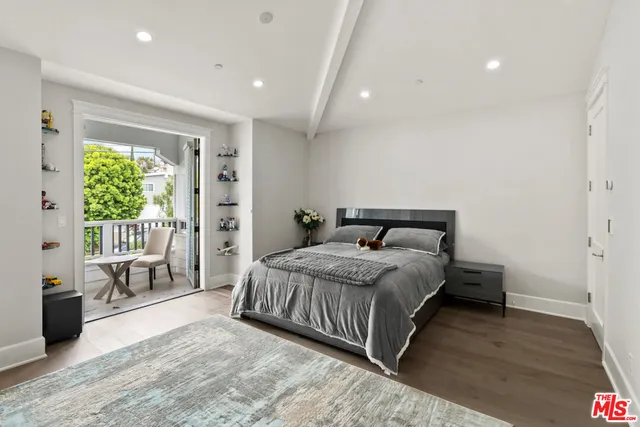 a bathroom with a granite countertop toilet sink and mirror