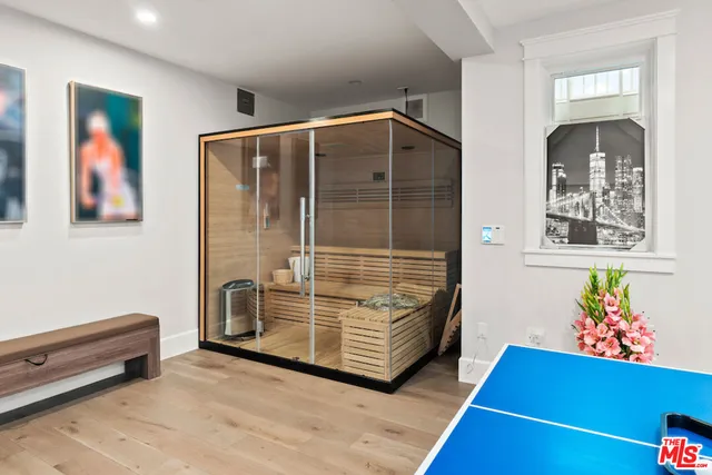 a view of a house with a yard and potted plants