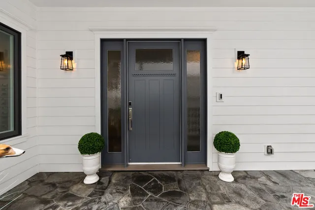 a view of a patio with table and chairs and potted plants