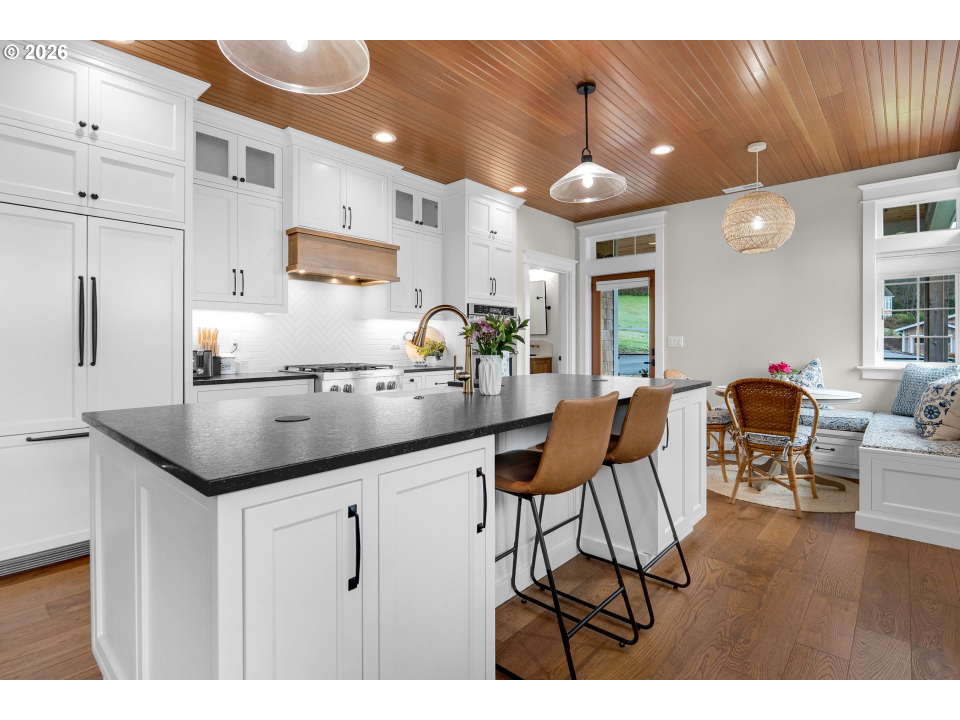 38590 Meadow Loop Nehalem, OR 97131 - Photo 15 of 48 a kitchen with stainless steel appliances kitchen island granite countertop a table chairs and a refrigerator