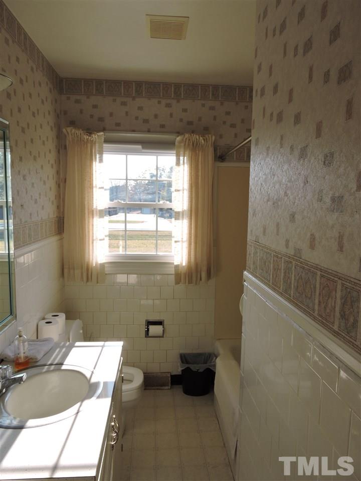 2580 Burlington Road Roxboro, NC 27574 - Photo 11 of 18 a bathroom with a sink and a mirror