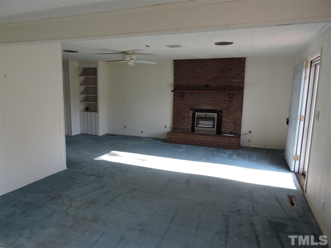 2580 Burlington Road Roxboro, NC 27574 - Photo 12 of 18 a view of empty room with a fireplace