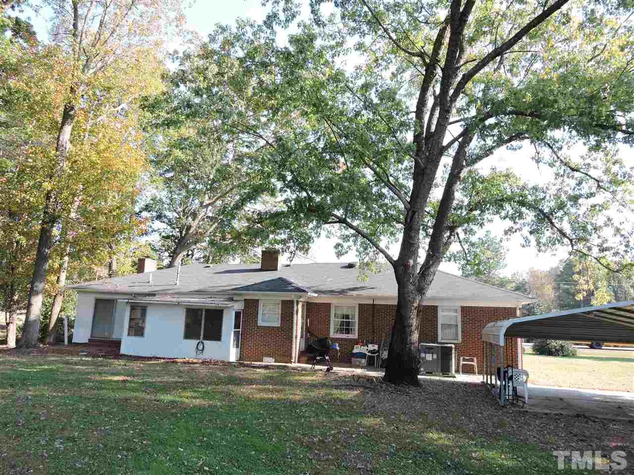 2580 Burlington Road Roxboro, NC 27574 - Photo 14 of 18 a front view of a house with a garden and trees