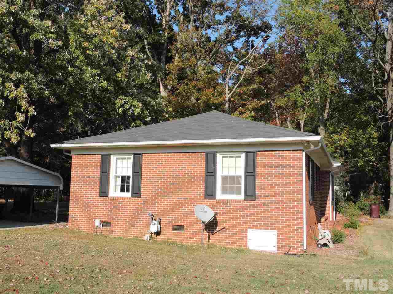 2580 Burlington Road Roxboro, NC 27574 - Photo 16 of 18 a backyard of a house with table and chairs