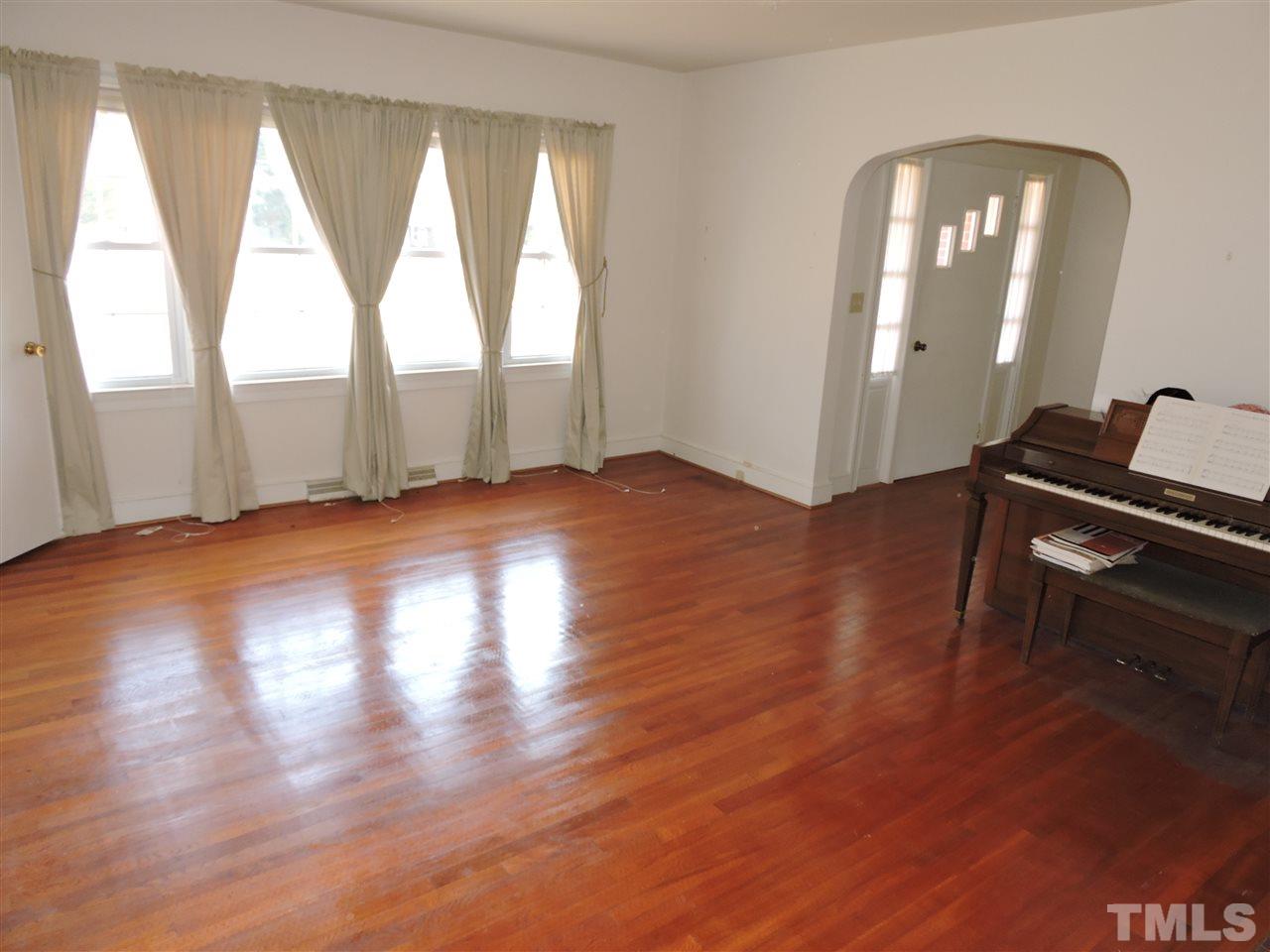 2580 Burlington Road Roxboro, NC 27574 - Photo 3 of 18 a view of empty room with wooden floor and fan