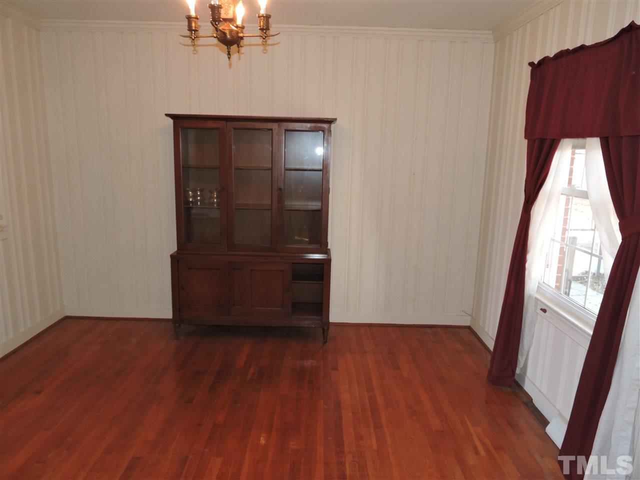 2580 Burlington Road Roxboro, NC 27574 - Photo 4 of 18 wooden floor in an empty room with a window
