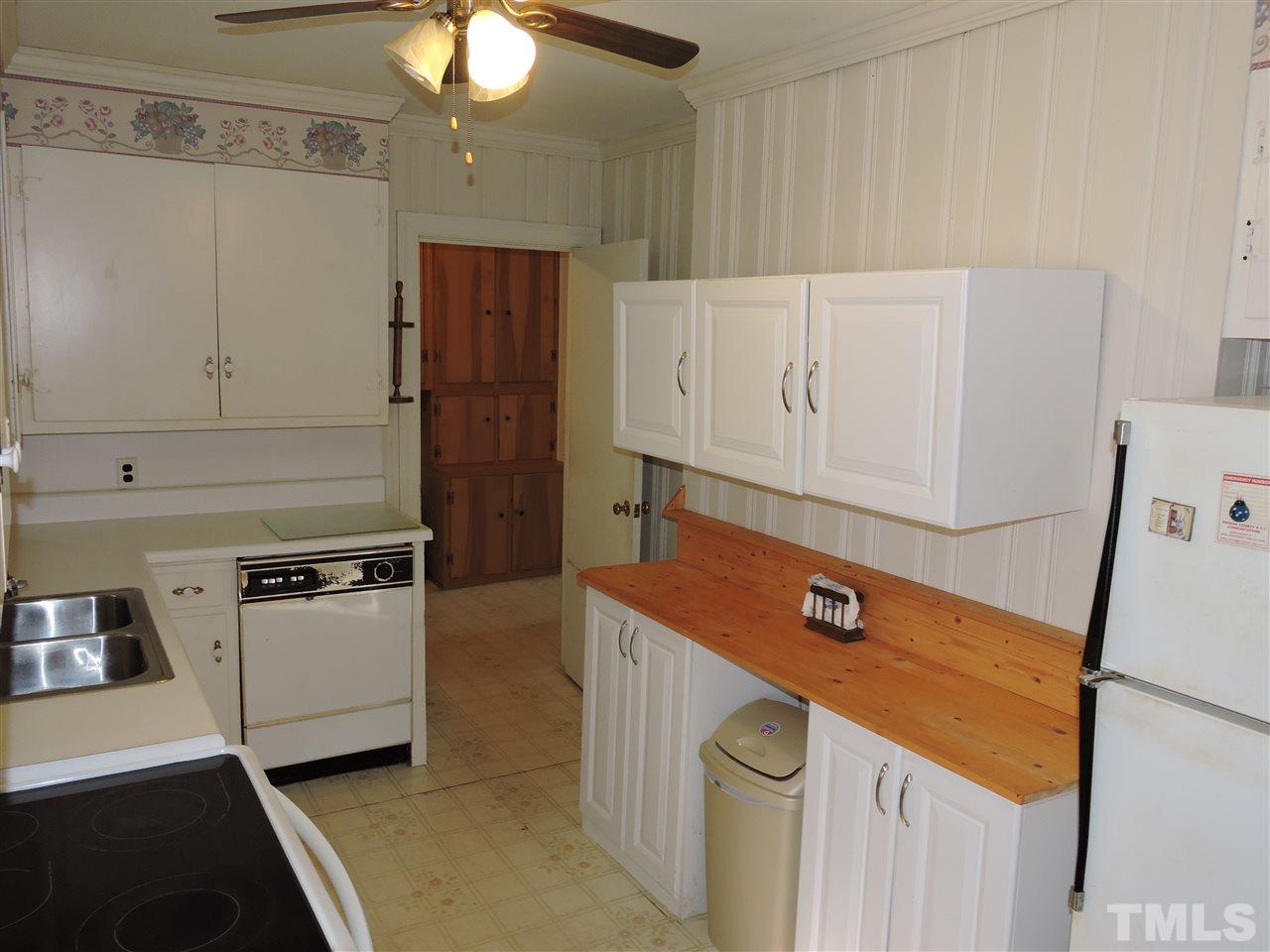 2580 Burlington Road Roxboro, NC 27574 - Photo 6 of 18 a kitchen with white cabinets and white appliances