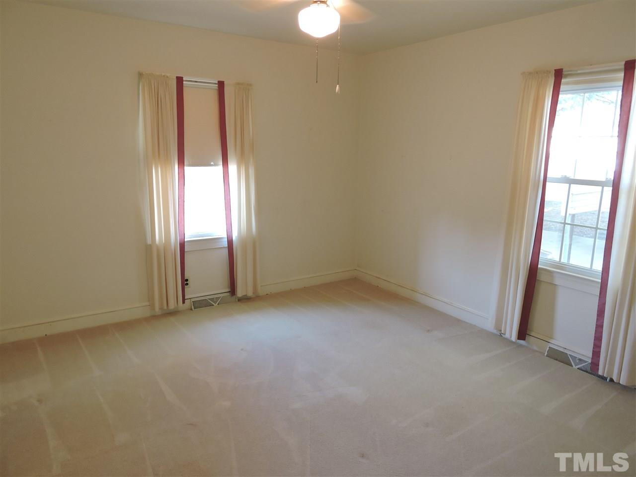 2580 Burlington Road Roxboro, NC 27574 - Photo 8 of 18 an empty room with windows and closet