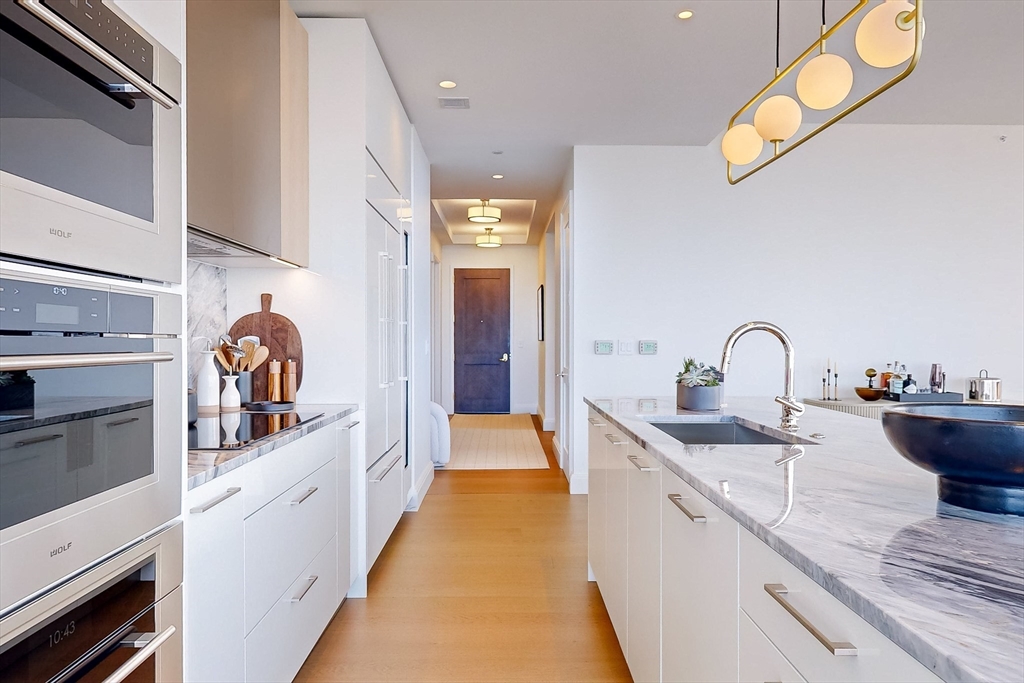 240 Devonshire Street, Unit 5206 Boston, MA 02110 - Photo 4 of 40 a view of a kitchen with a sink and cabinets