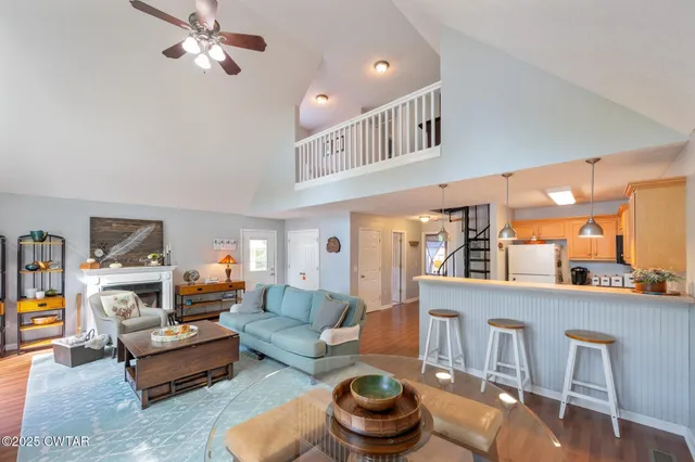 a living room with furniture a rug and a chandelier