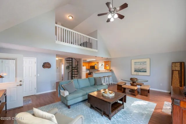 a living room with furniture two view and a window