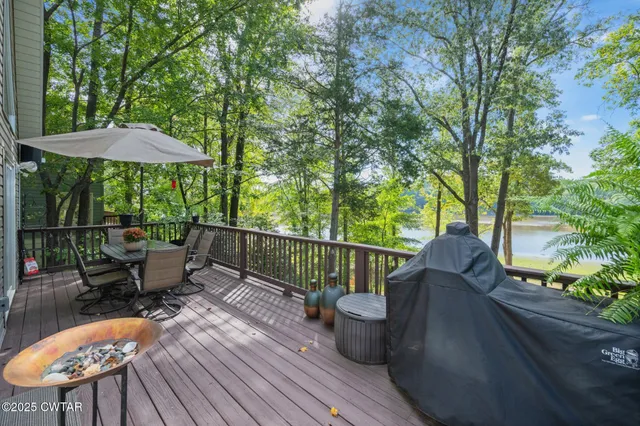 a view of balcony with furniture and umbrella