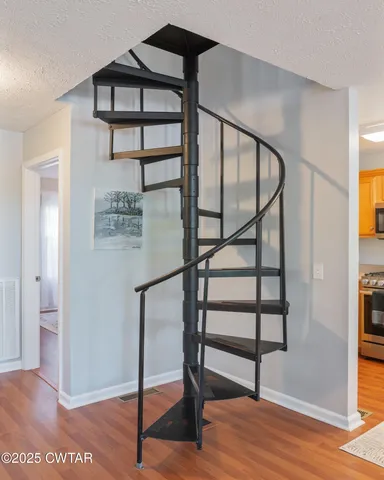 a view of staircase with a rug