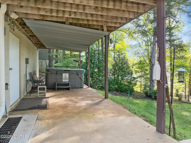 a view of backyard with plants and outdoor seating