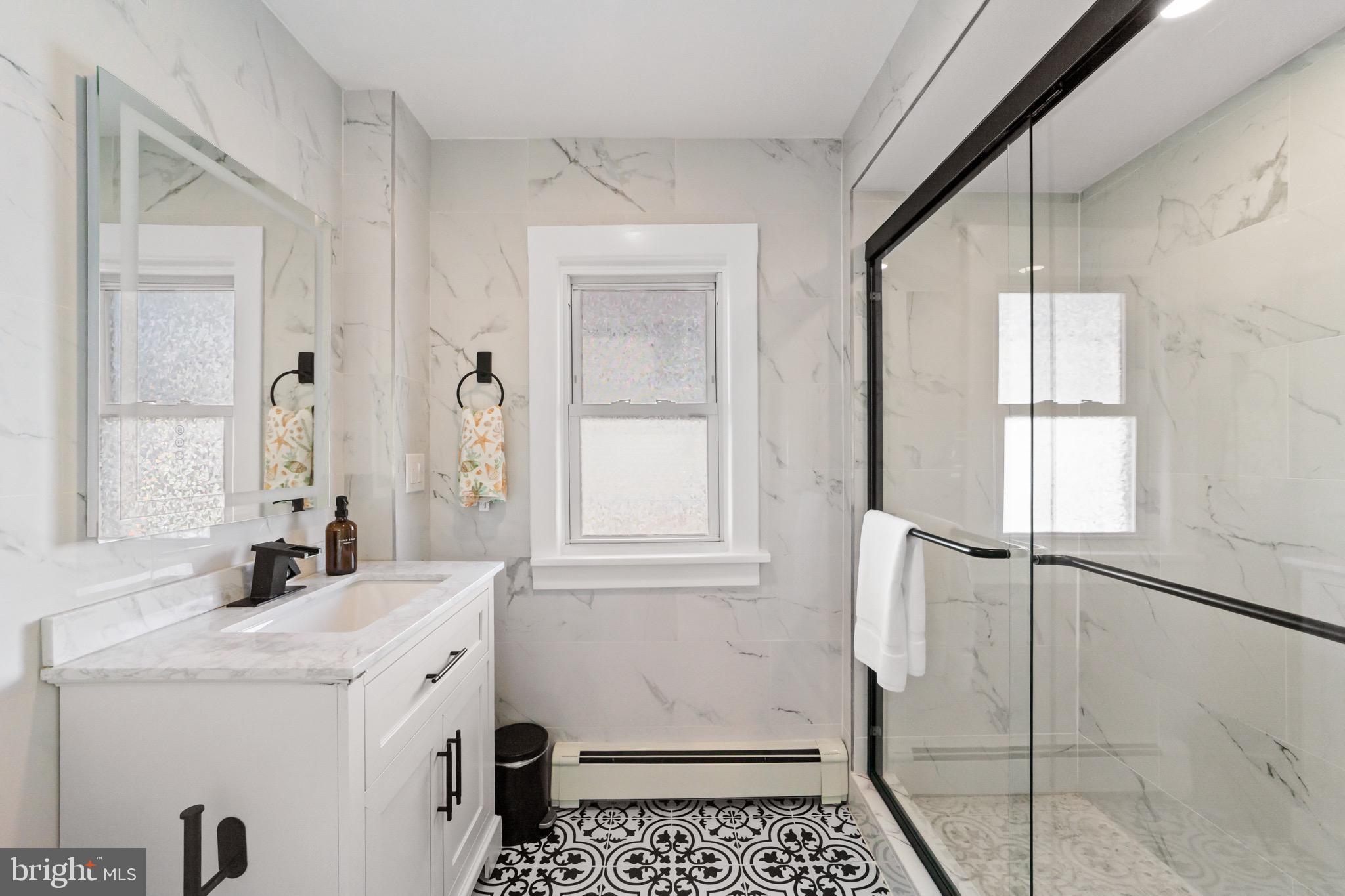 140 North Ocean Avenue Point Pleasant Beach, NJ 08742 - Photo 13 of 49 a bathroom with a sink a vanity and a mirror