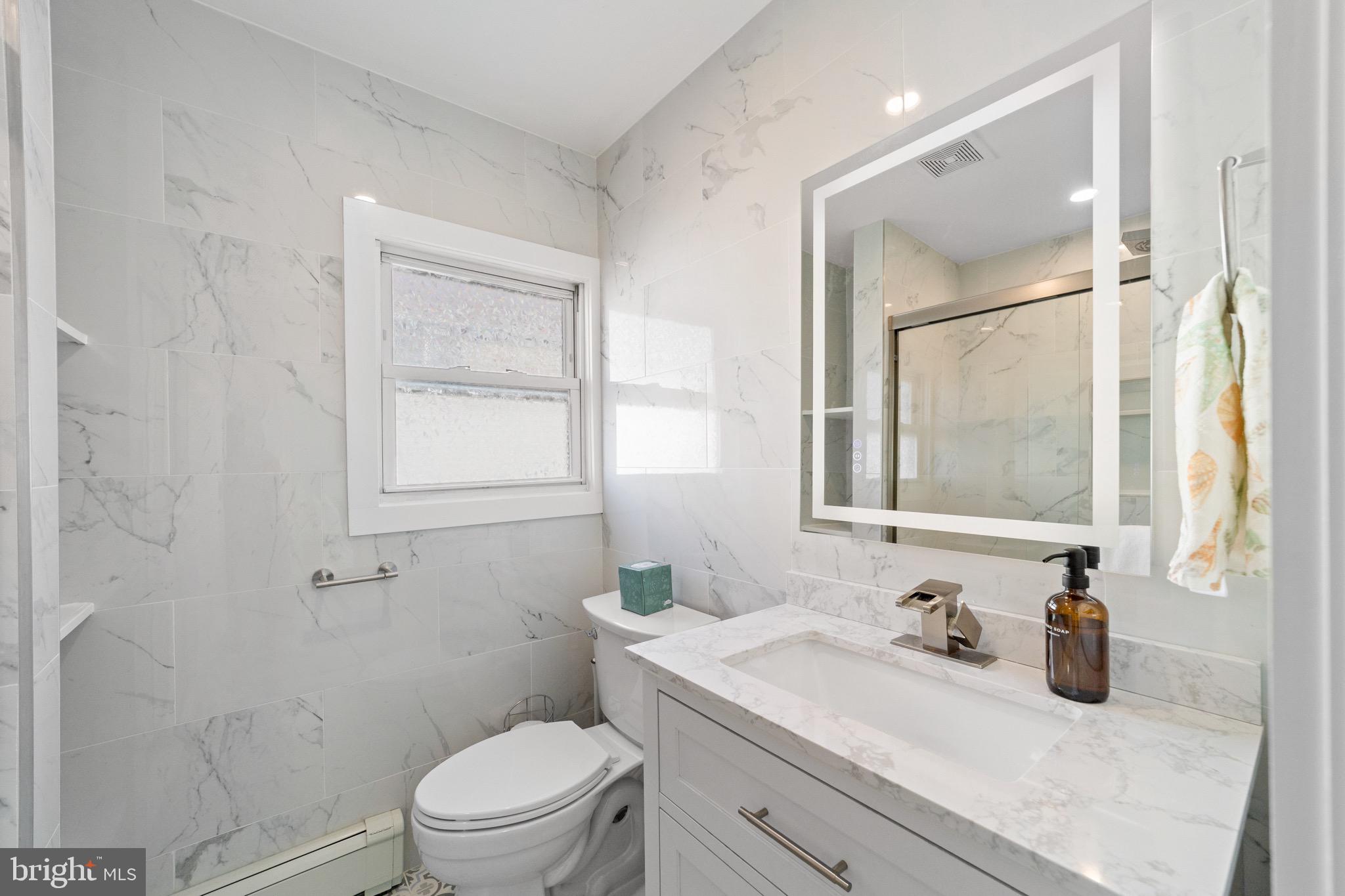 140 North Ocean Avenue Point Pleasant Beach, NJ 08742 - Photo 14 of 49 a bathroom with a granite countertop sink toilet a mirror and shower