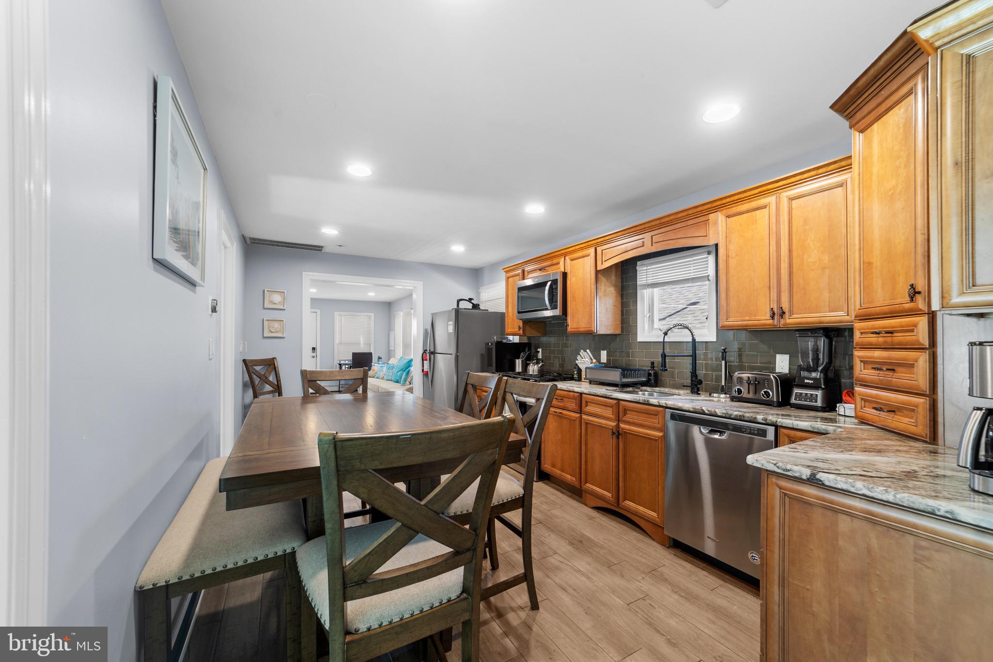 140 North Ocean Avenue Point Pleasant Beach, NJ 08742 - Photo 24 of 49 a kitchen with a table chairs sink and cabinets
