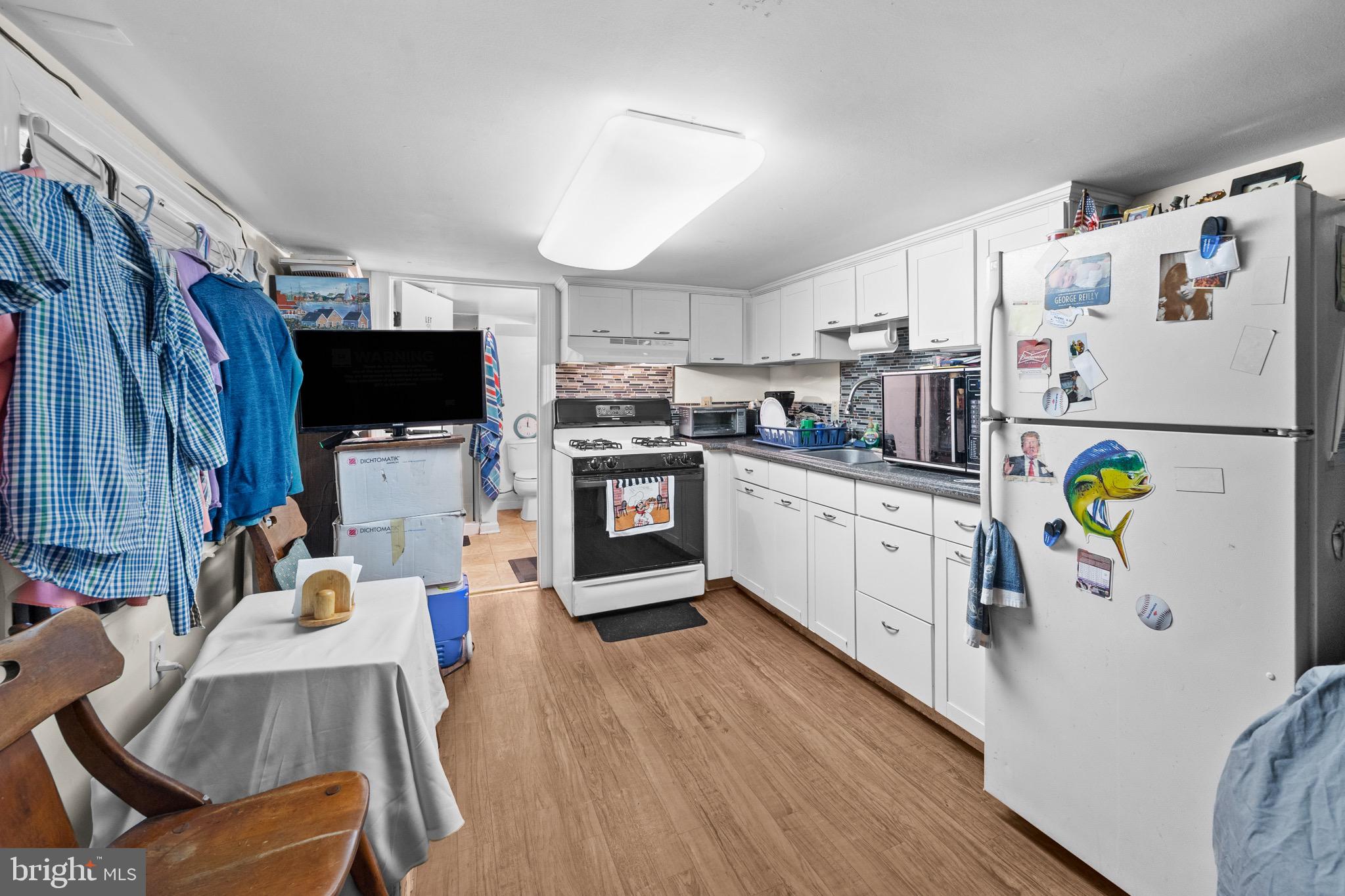 140 North Ocean Avenue Point Pleasant Beach, NJ 08742 - Photo 32 of 49 a kitchen with stainless steel appliances a stove a refrigerator sink a microwave and cabinets