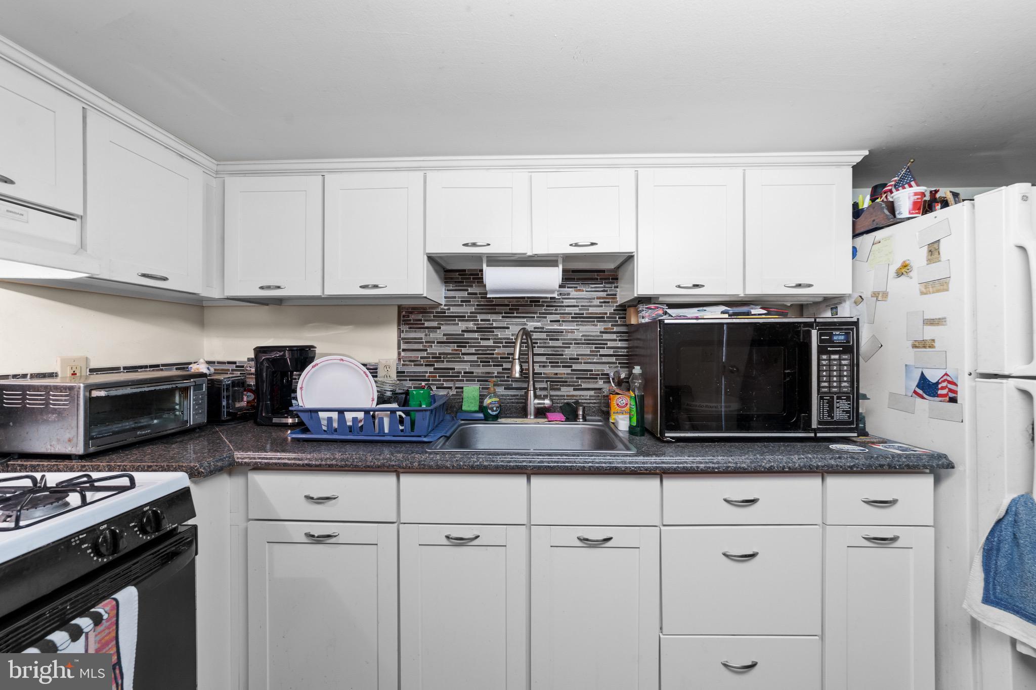 140 North Ocean Avenue Point Pleasant Beach, NJ 08742 - Photo 33 of 49 a kitchen with stainless steel appliances a stove a microwave a refrigerator a stove and white cabinets
