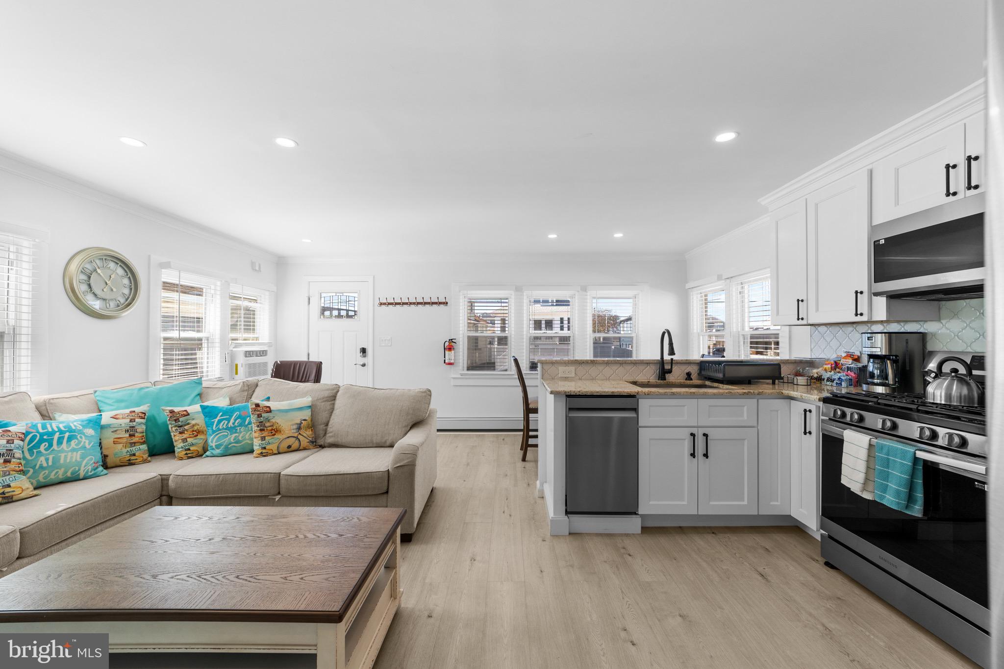 140 North Ocean Avenue Point Pleasant Beach, NJ 08742 - Photo 7 of 49 a large white kitchen with stainless steel appliances granite countertop a stove and a refrigerator
