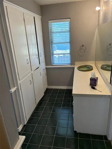 a bathroom with a granite countertop toilet and a shower