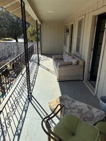 a view of a swimming pool with an outdoor seating and a yard