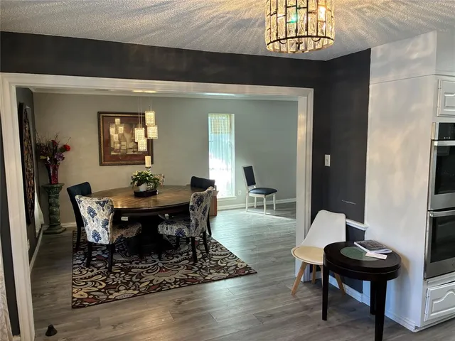 a kitchen with granite countertop a stove and a refrigerator