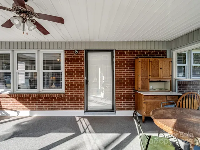 a view of a livingroom with furniture and a large window