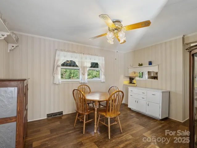 a view of a dining room with furniture and window